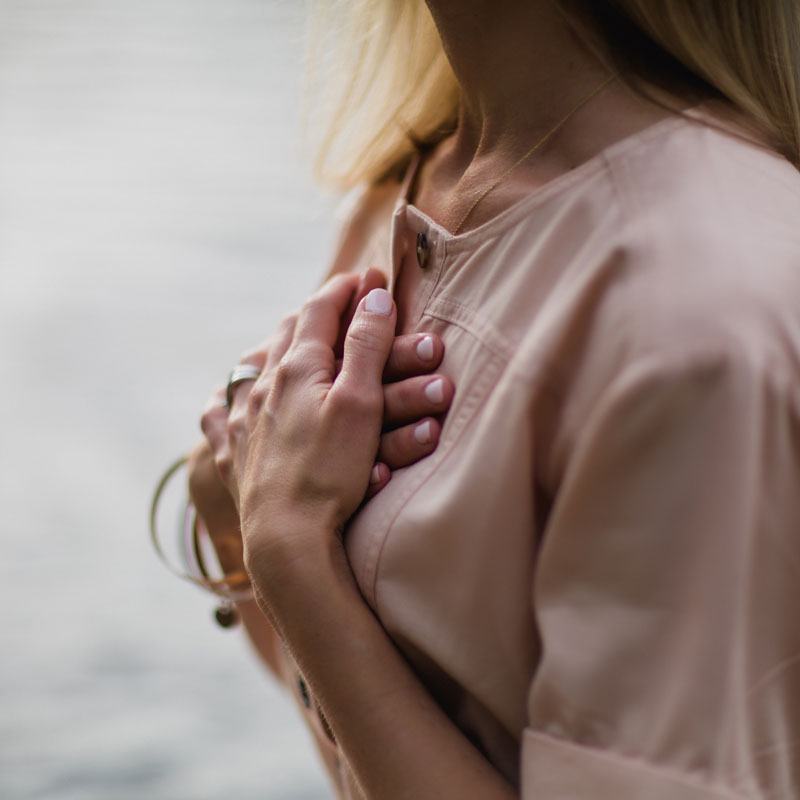 A woman with her hands on her chest